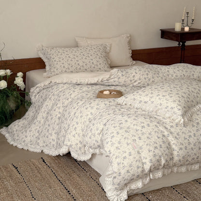 Ivory blue rose bedding set with ruffled pillowcases, flat sheet, and lace-trimmed duvet cover