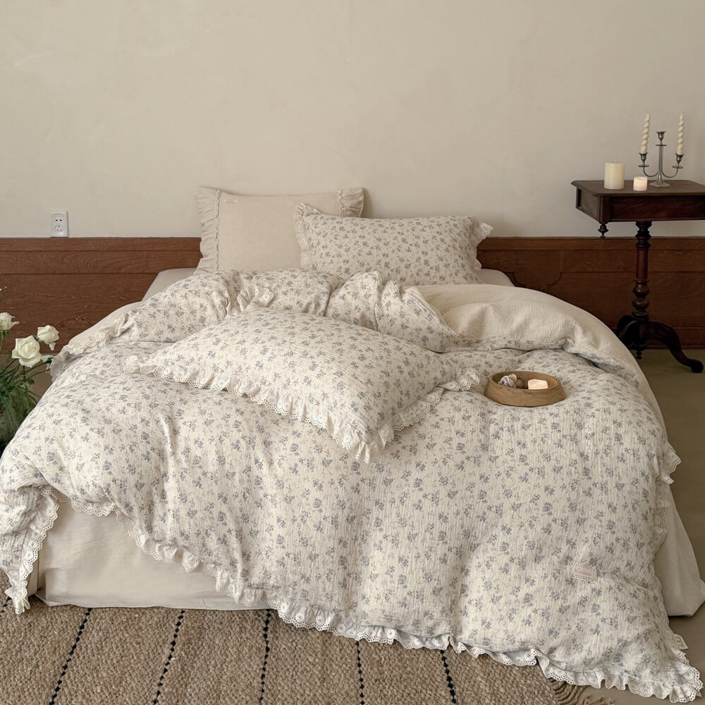 Full view of blue rose cotton linen bedding set with ivory base and romantic lace trim