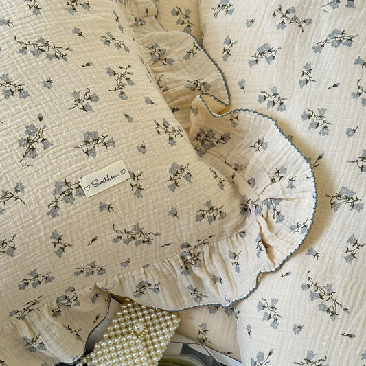 Detail of the ruffle duvet cover set texture and gray hyacinth floral print.