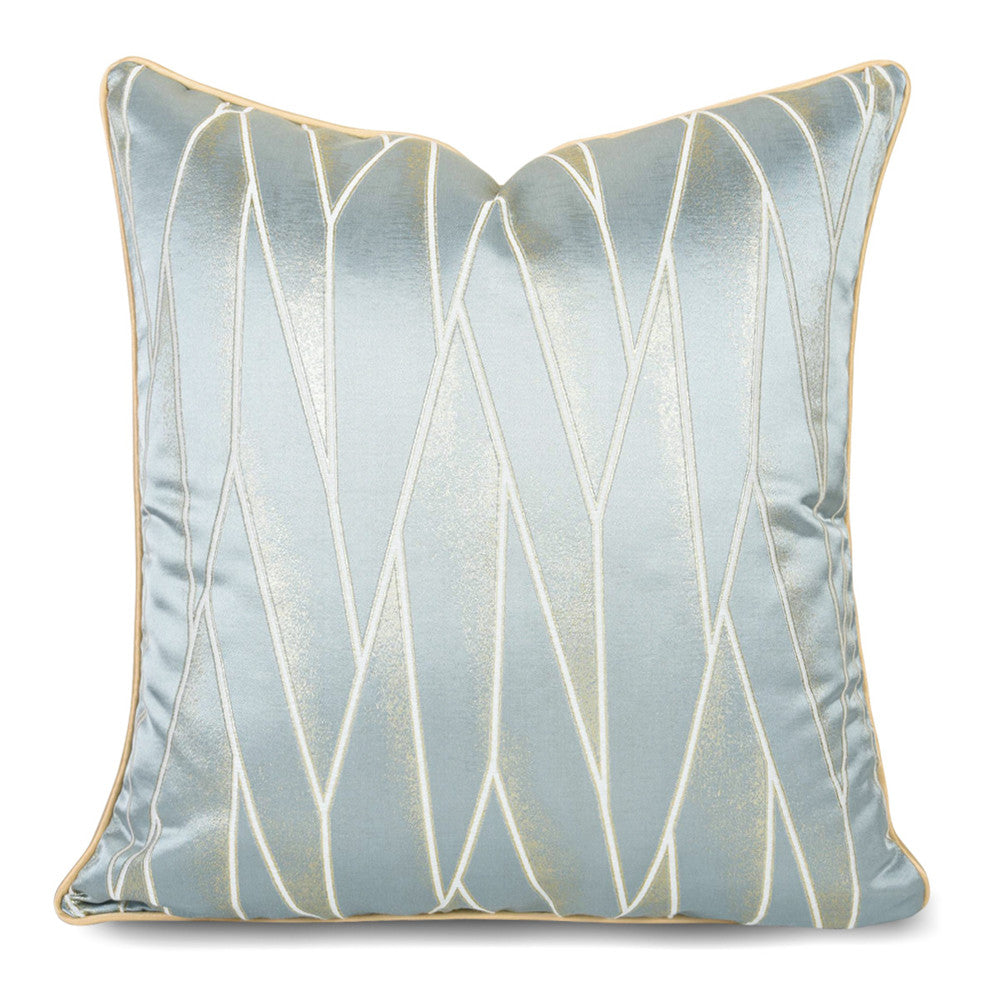 Modern geometric decorative pillow cover with metallic gold accents on light blue fabric