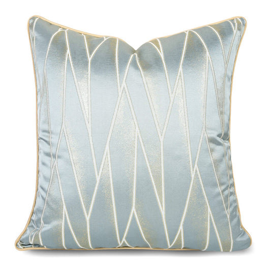 Modern geometric decorative pillow cover with metallic gold accents on light blue fabric