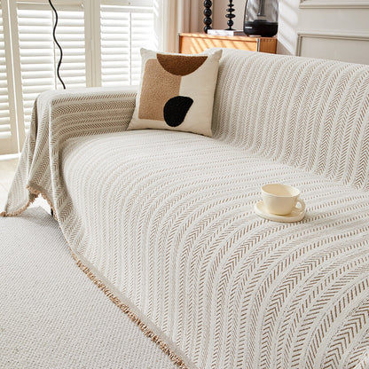 Modern herringbone cotton one-piece sofa cover in neutral living room with accent pillow