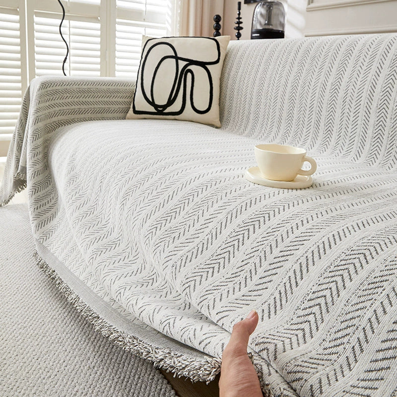 Modern herringbone cotton sofa cover in white with abstract pillow and coffee cup, StuffedHome