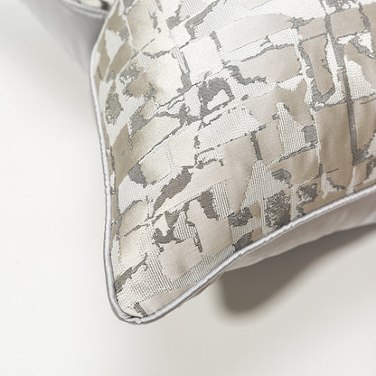 Modern metallic decorative pillow cover with abstract silver pattern on light fabric