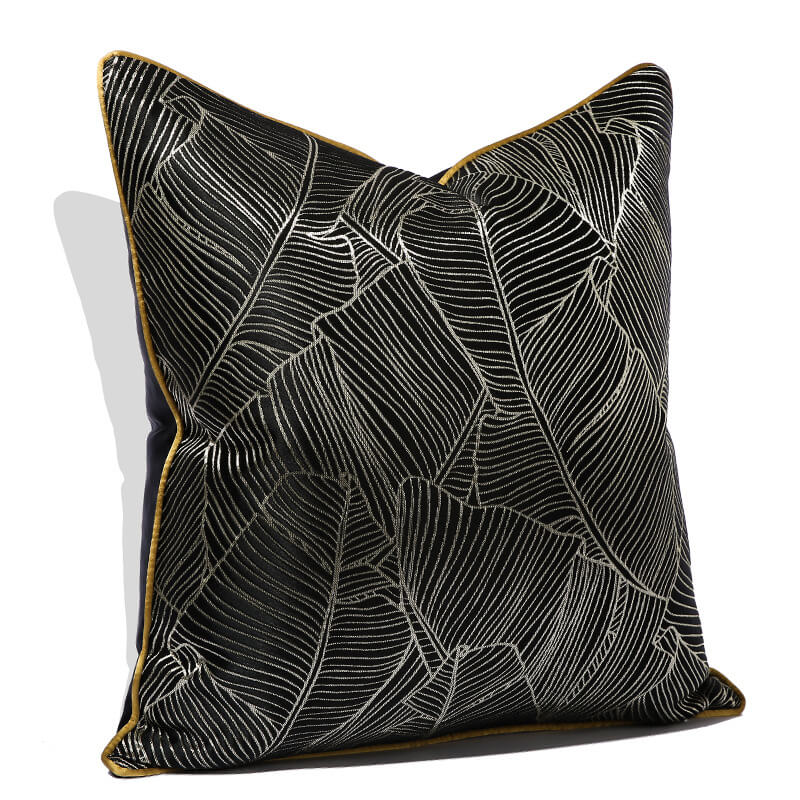 Black cushion cover with minimalist white leaf pattern and yellow piping, modern home decor