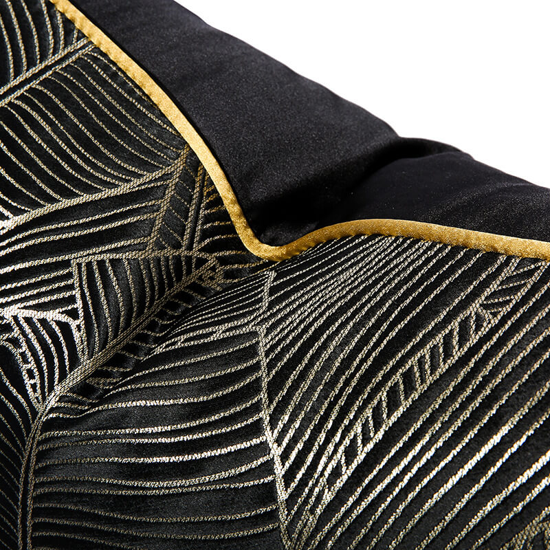 Modern black cushion cover with gold minimalist leaf pattern and yellow trim from StuffedHome