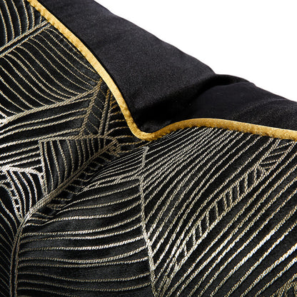 Modern black cushion cover with gold minimalist leaf pattern and yellow trim from StuffedHome