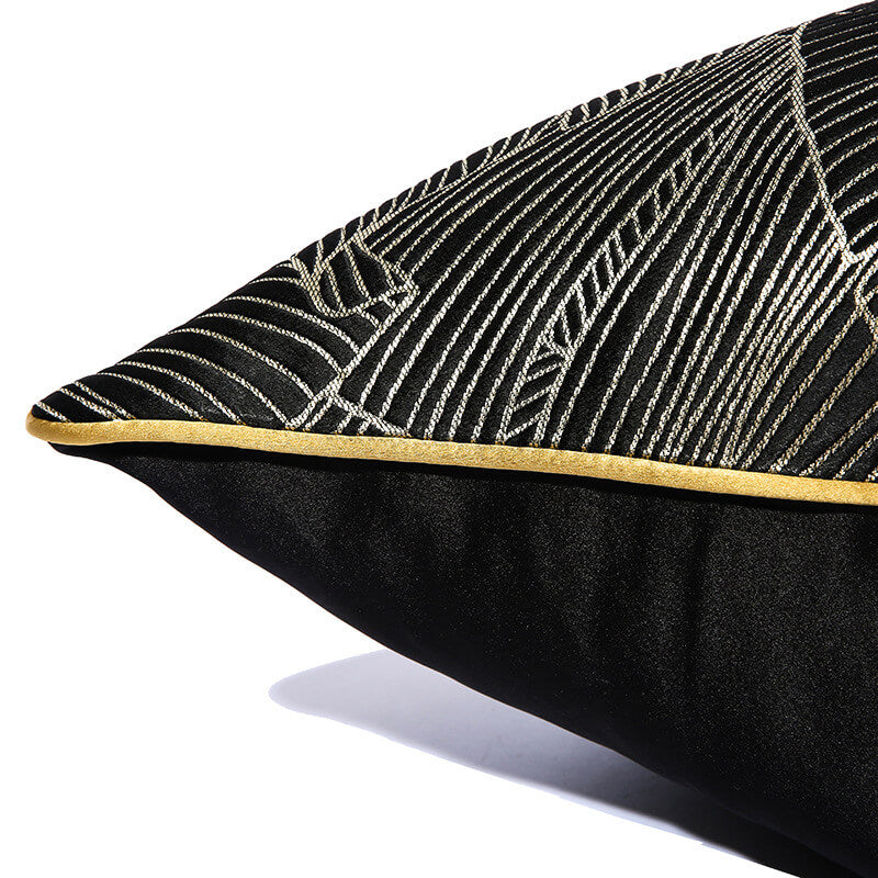Modern black cushion cover with gold minimalist leaf pattern and gold trim, StuffedHome