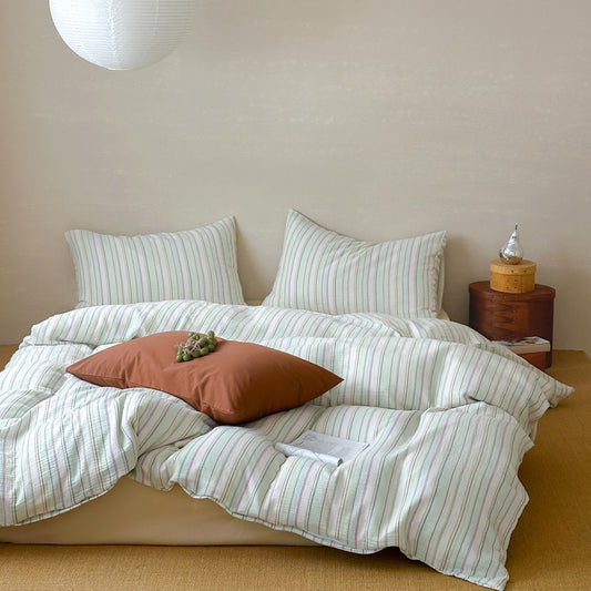 Modern striped duvet cover set with matching pillowcases on a cozy bed in a minimalist bedroom