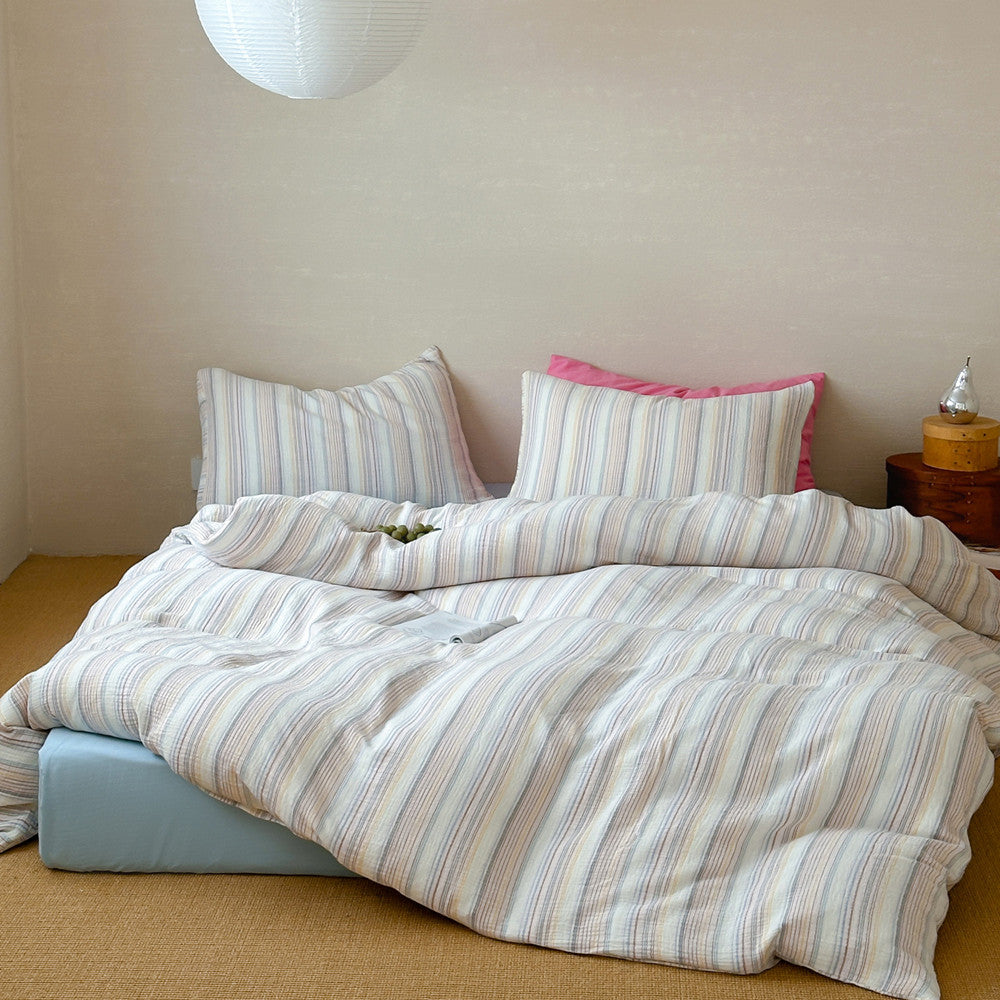 Modern striped duvet cover set with matching pillows on a cozy, inviting bed