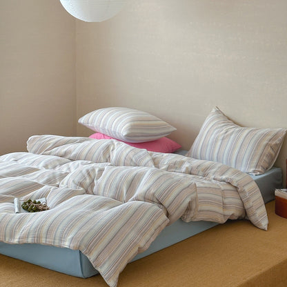 Modern striped duvet cover set with matching pillows on a bed in a cozy bedroom