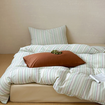 Modern striped duvet cover set with matching pillow on a cozy, light-colored bed