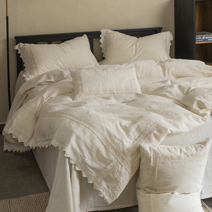 Full view of the Natural Linen Cotton Bedding Set, featuring a crisp white duvet cover, matching shams with lace trim, and decorative accent pillows on a wooden bed, highlighting the rustic farmhouse style.