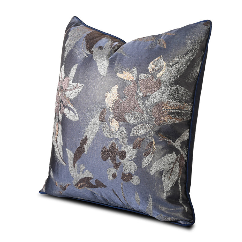 Straight-on view of navy floral accent pillow on white background