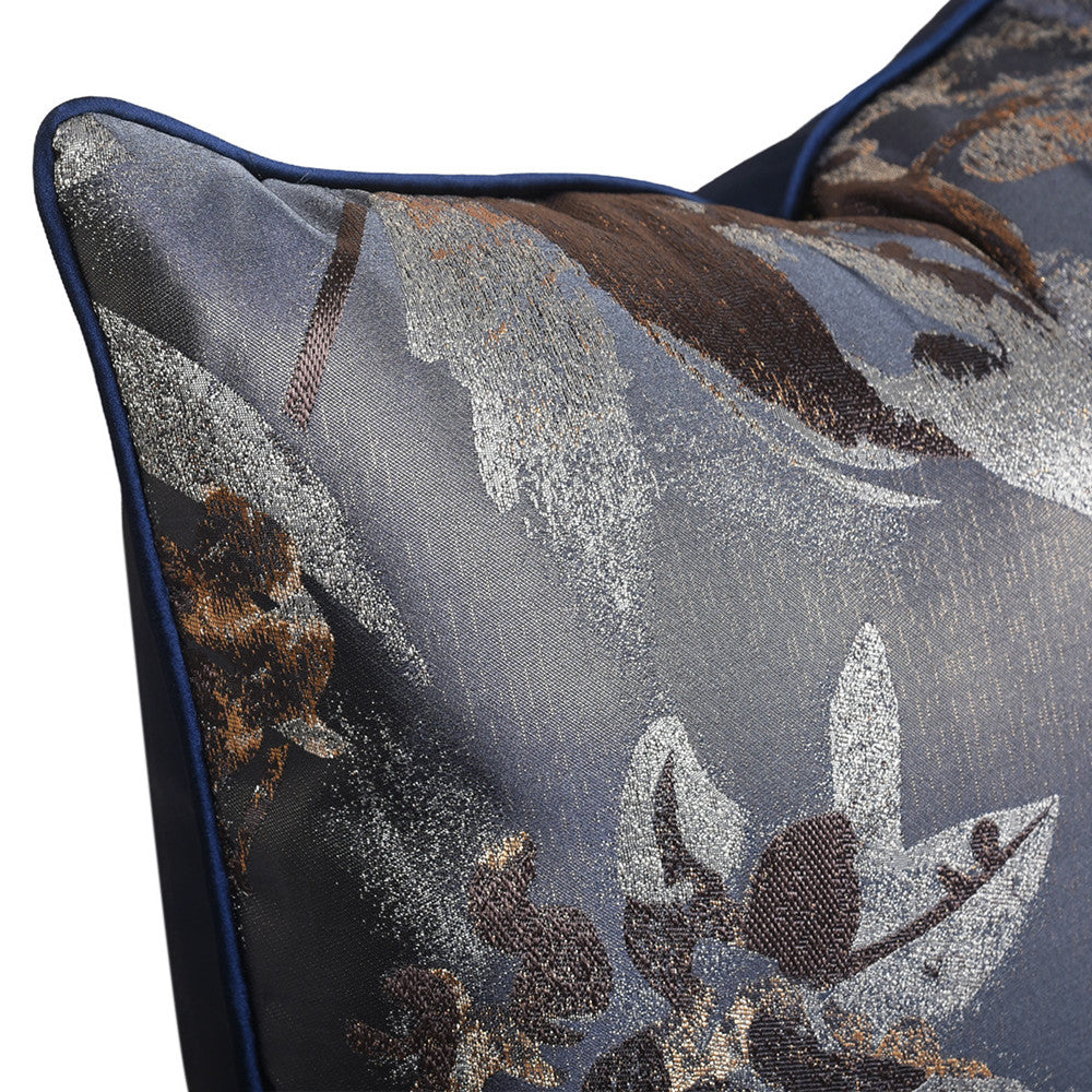 Close-up of metallic silver floral jacquard pattern on navy fabric