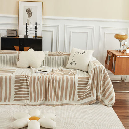 Beige geometric sofa cover in a modern living room with decorative pillows and minimalist decor