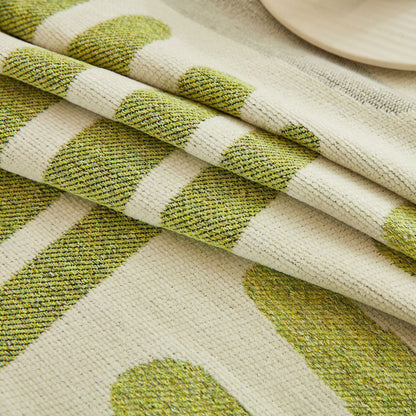 Reversible geometric sofa cover with green and cream stripes, sustainable cotton fabric