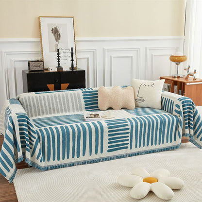 Modern living room with geometric reversible sofa cover, abstract pillows, and flower rug