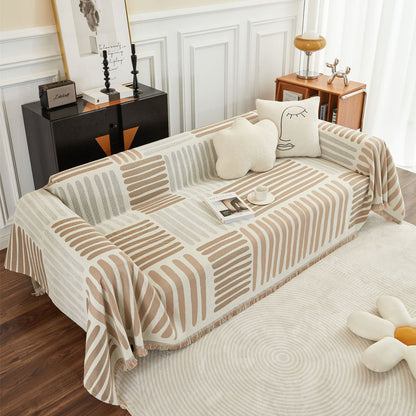 Reversible geometric sofa cover in beige and taupe on modern sofa with plush pillows, StuffedHome decor