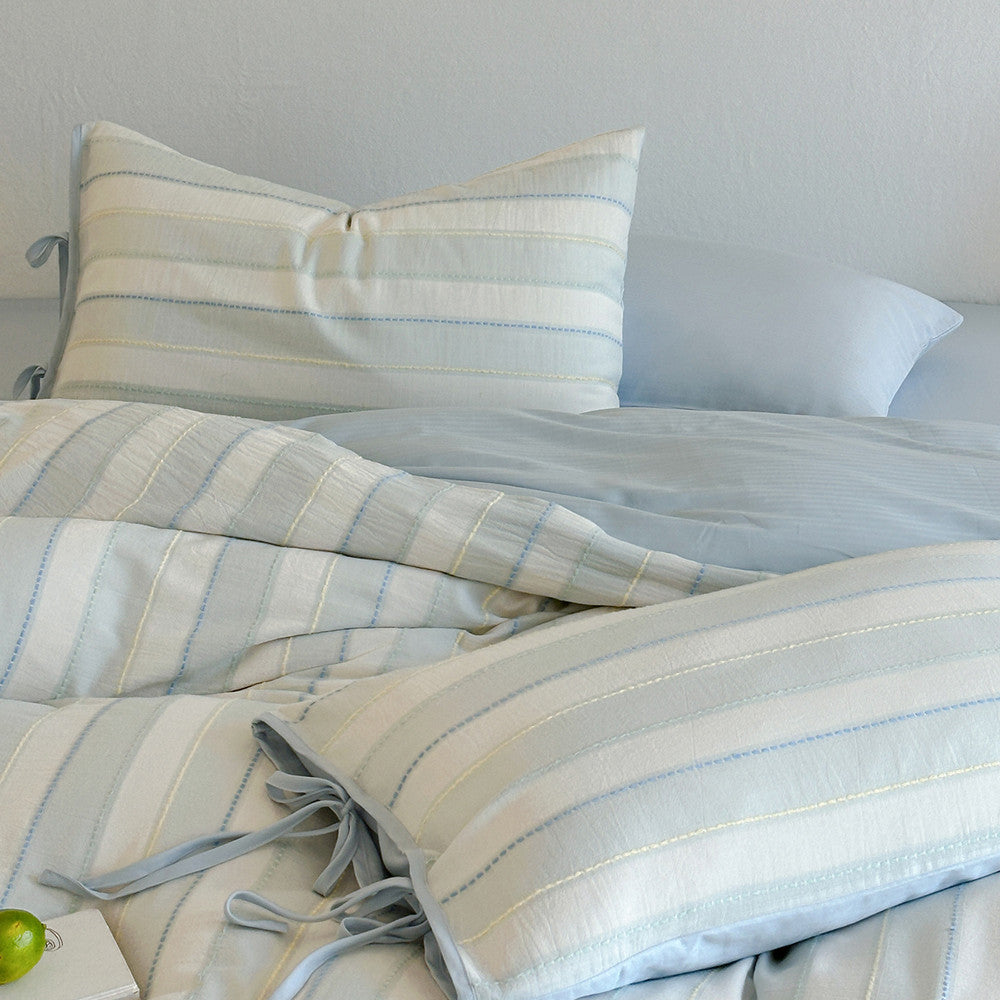 Detailed close-up of blue Pastel Cotton Striped Bedding Set, focusing on the striped texture and pillow ties.