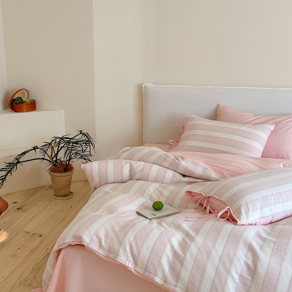 Styled bedroom featuring the pink Pastel Cotton Striped Bedding Set, highlighting the soft, cozy, pastel atmosphere.