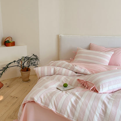 Styled bedroom featuring the pink Pastel Cotton Striped Bedding Set, highlighting the soft, cozy, pastel atmosphere.