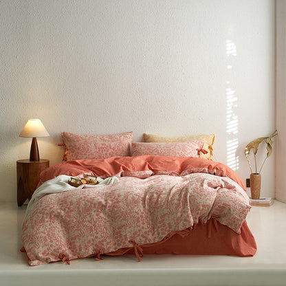 Full bed view of coral premium cotton floral jacquard bedding set, featuring tie closures.
