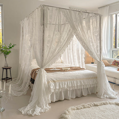 Elegant bedroom with floral lace bed canopy curtains, white cotton bedding, cozy decor