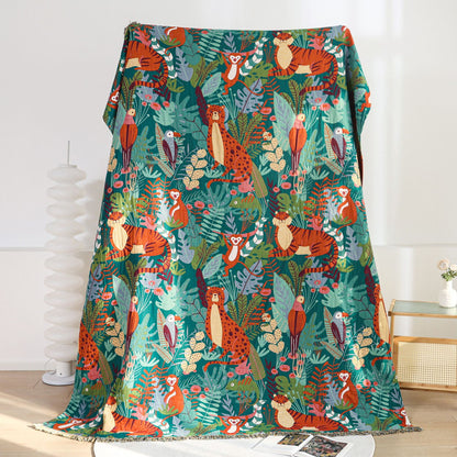 Full vertical view of the Jungle Animal Cotton Jacquard Throw Blanket, displaying the complete pattern of tigers, leopards, monkeys, and toucans set against lush tropical green foliage.