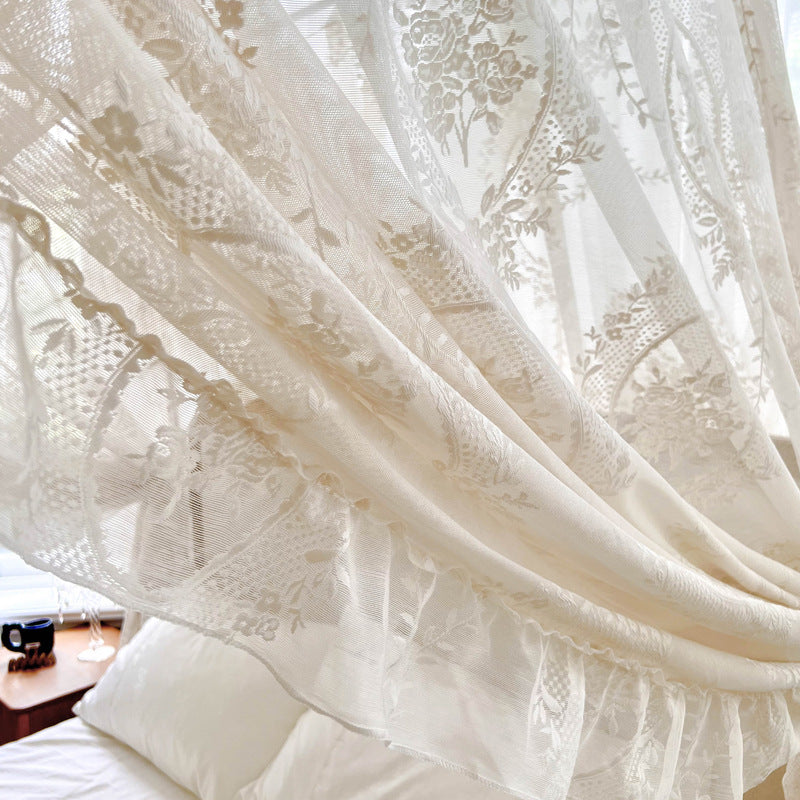 Romantic lace bed canopy curtain with floral patterns over cozy cotton bedding