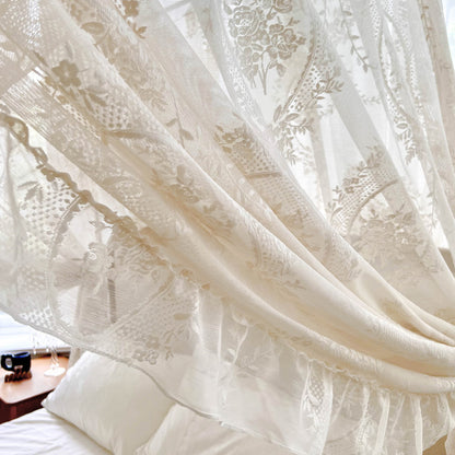 Romantic lace bed canopy curtain with floral patterns over cozy cotton bedding