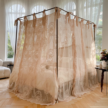 Romantic lace bed canopy curtain with ties over a cozy bed in a bright bedroom