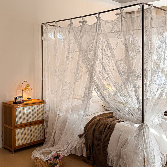 Romantic lace canopy curtains on a four-poster bed in a cozy, elegant bedroom setting