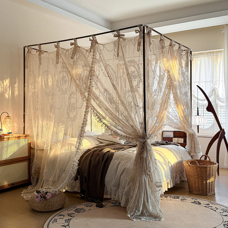 Romantic lace canopy curtains on a 4-poster bed in a cozy, sunlit bedroom.