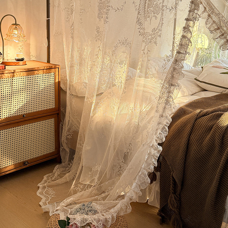 Romantic lace bed canopy curtains on a cozy four-poster bed with soft bedding.