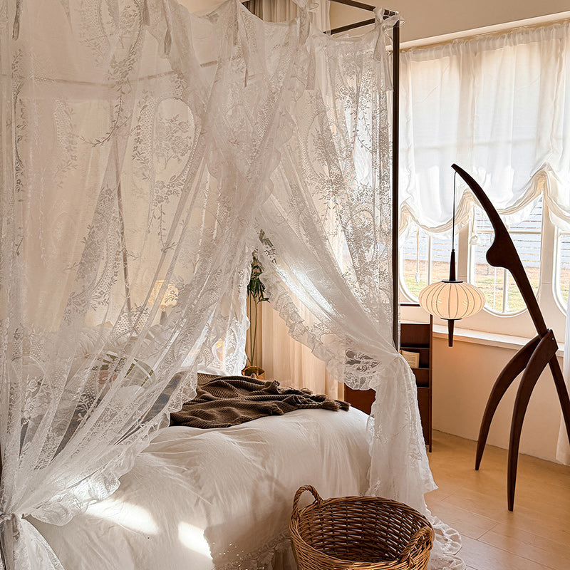 Romantic lace canopy curtains on a four-poster bed in a sunlit cozy bedroom