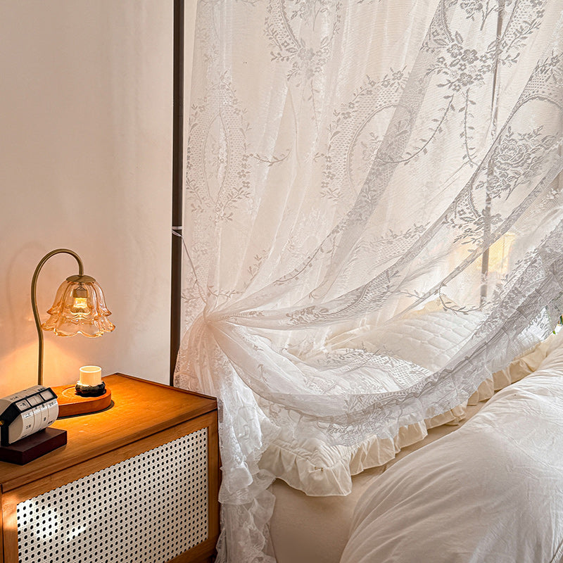 Elegant lace bed canopy curtains on a four-poster bed with soft cotton bedding