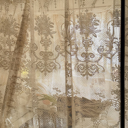 Decorative curtain with intricate floral and paisley patterns in beige and brown tones.