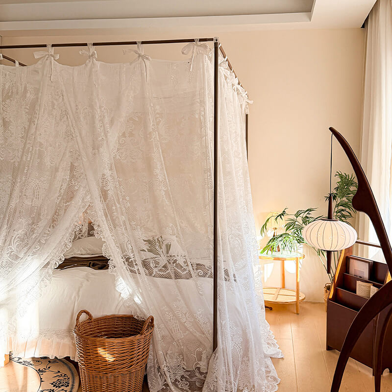 Bed with lace canopy in a bedroom setting