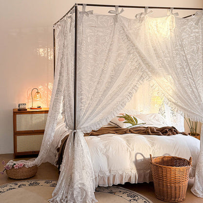 Bedroom with a canopy bed draped in white lace curtains, wooden nightstands, and decorative elements.
