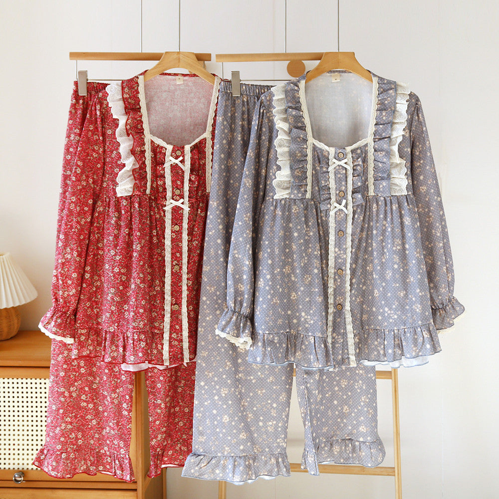 Two floral lace ruffled cotton pajama sets in red and blue, long sleeve and pants, hanging on hangers