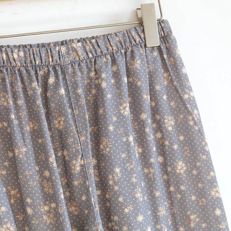 Close-up of floral print cotton pajama pants with elastic waistband on hanger