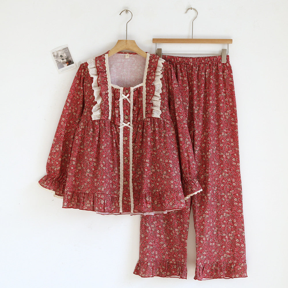 Red floral cotton pajama set with lace ruffles, long sleeves, and relaxed pants on hangers