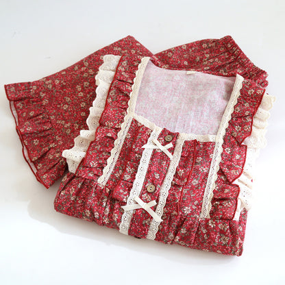 Red floral cotton pajama set with lace trim and ruffled details, folded neatly.