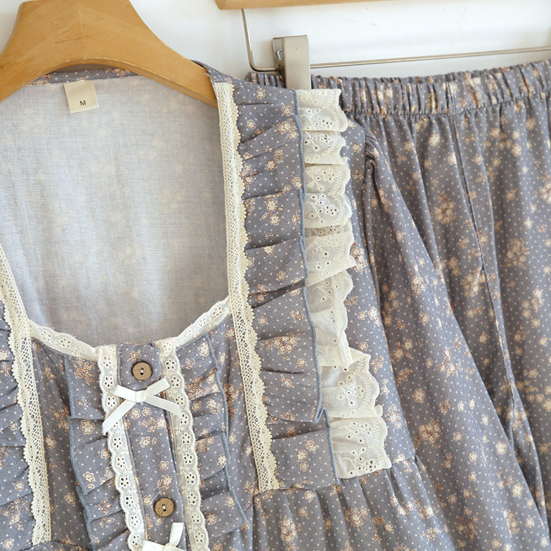 Blue floral cotton pajama set with lace trim and ruffle details on a hanger