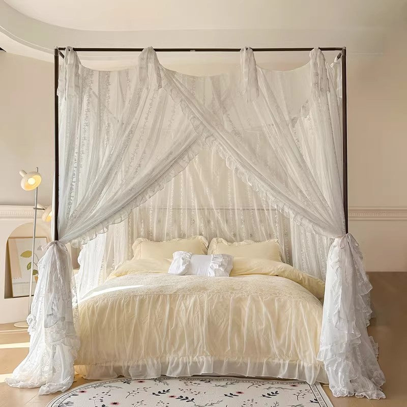 Romantic white lace canopy bed curtains with ruffles in a cozy bedroom at StuffedHome