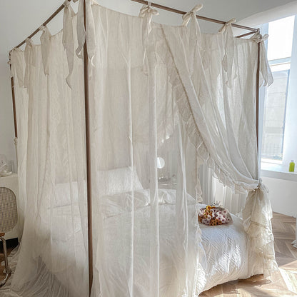 Romantic ruffled cotton canopy curtains on four-poster bed in bright, cozy bedroom