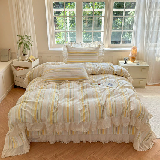 Ruffled stripe cotton bedding set with lace trim in a bright, cozy bedroom setting