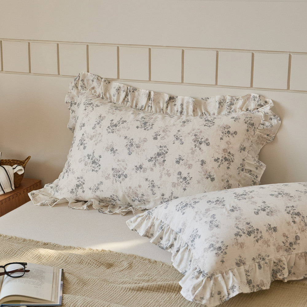 Aesthetic cottagecore bedroom styling featuring floral cotton muslin ruffle pillow shams on a cozy bed