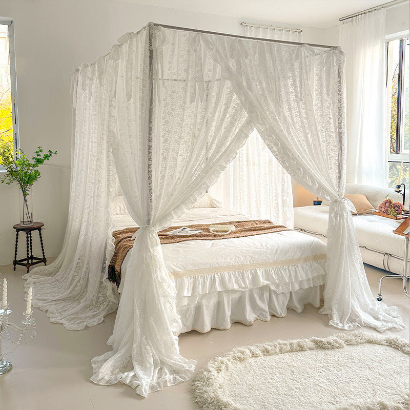 Sheer lace bed canopy in a bright bedroom with cozy natural cotton bedding by StuffedHome